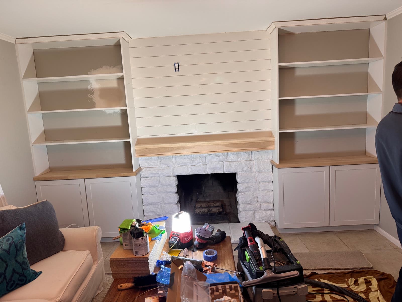 Shiplap fireplace wall with white oak mantel and flanking built-in bookcases, Carlsbad