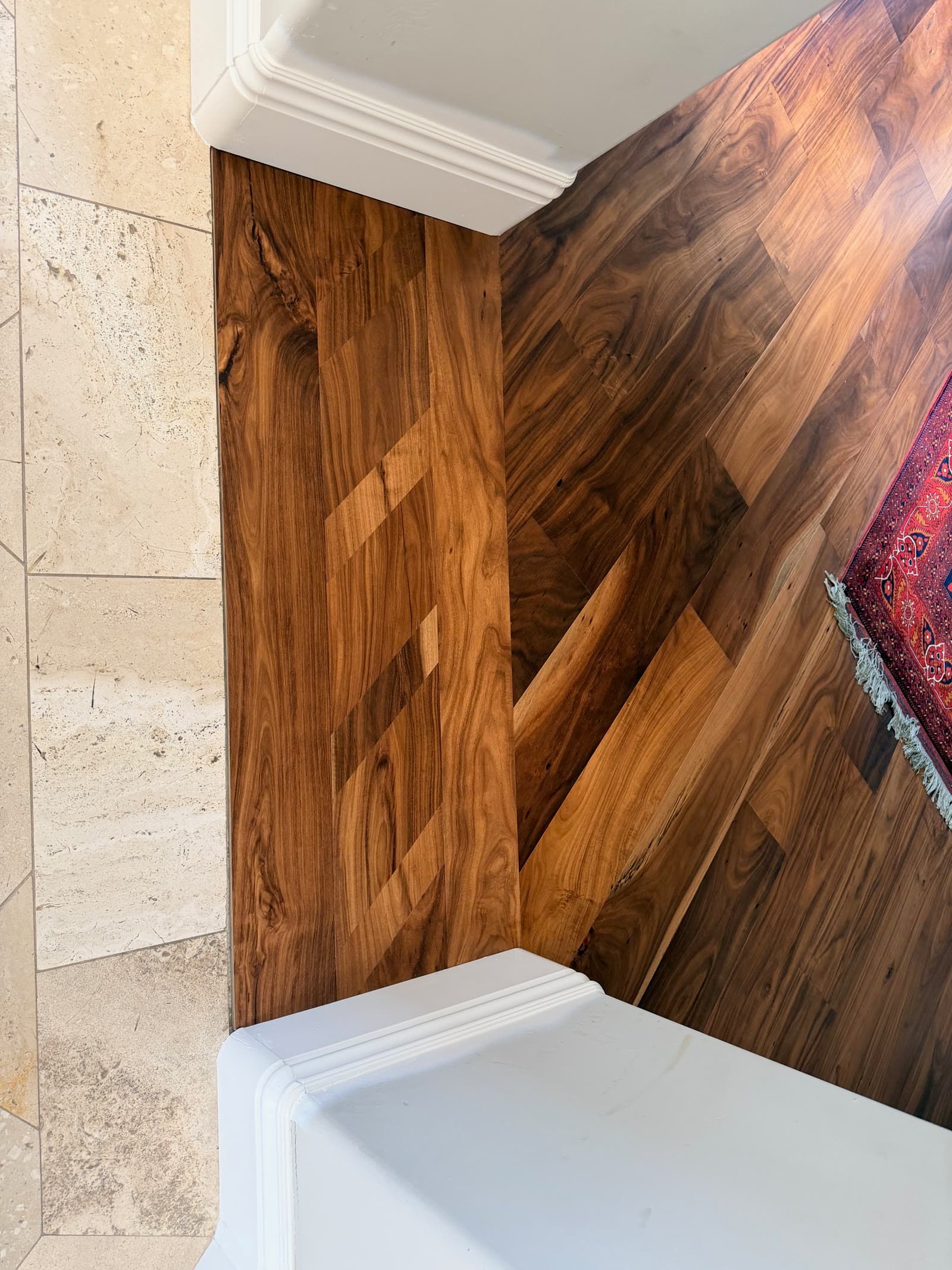 Acacia hardwood scribed into a corner between two painted column bases