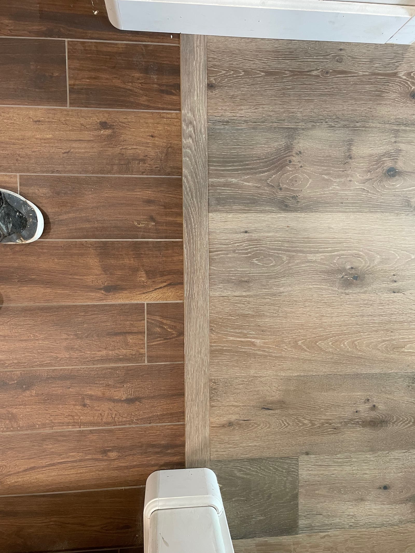 Wood-look tile meeting white oak plank with a solid oak transition strip, Encinitas