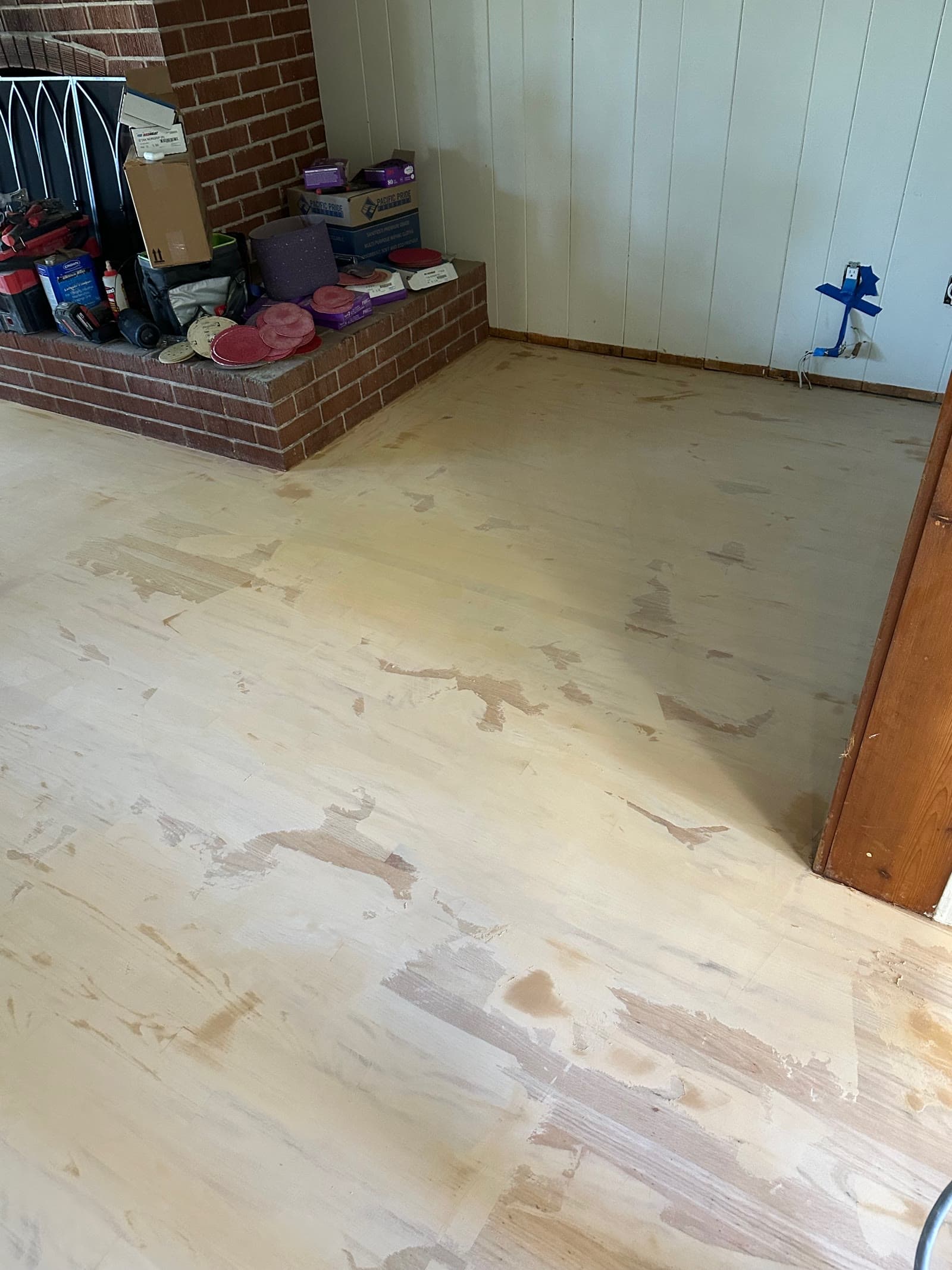 Red oak floor part-way through sanding, with old finish still visible in patches
