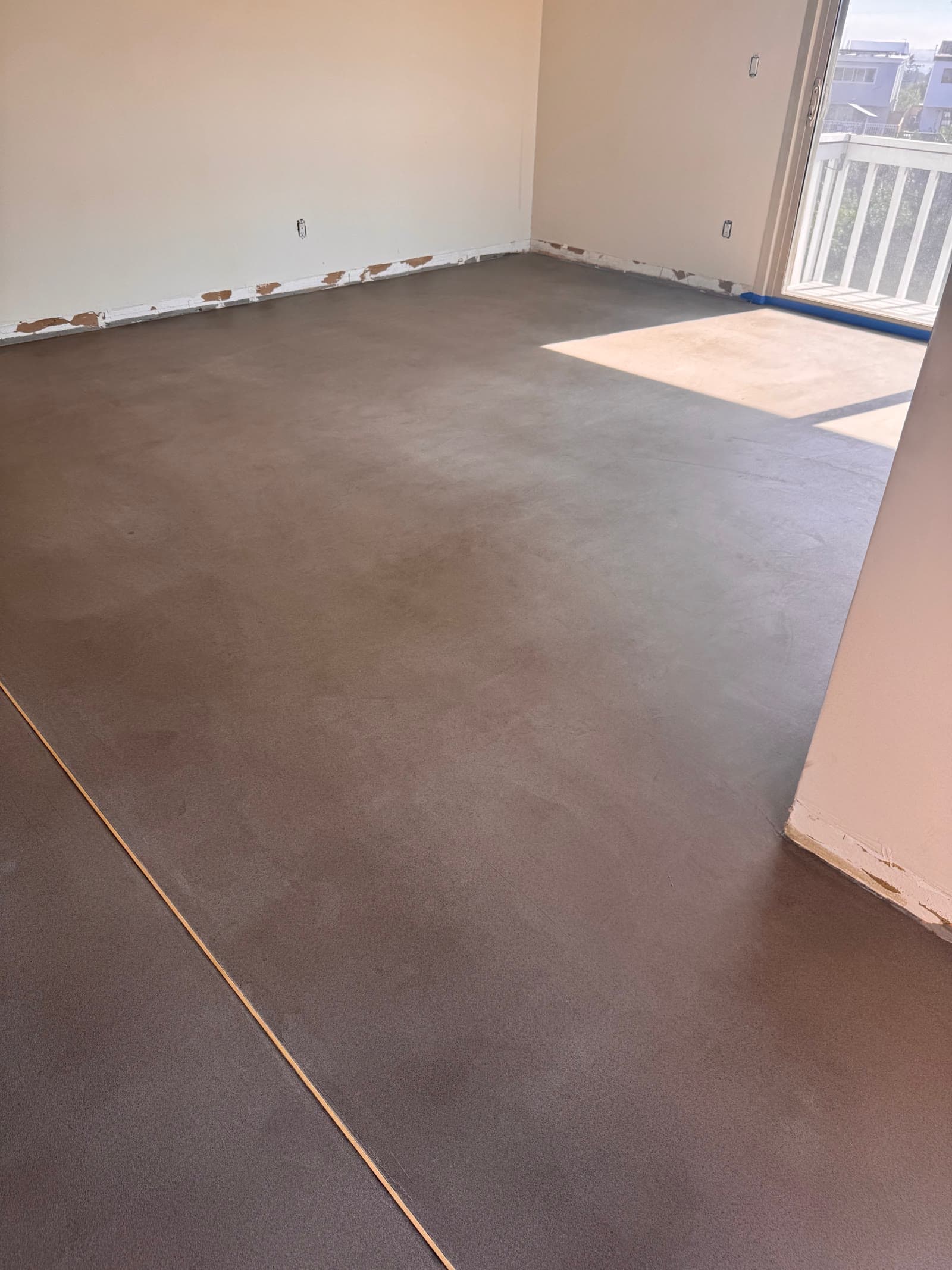 Troweled moisture barrier over a slab in an oceanfront La Jolla condo before plank goes down