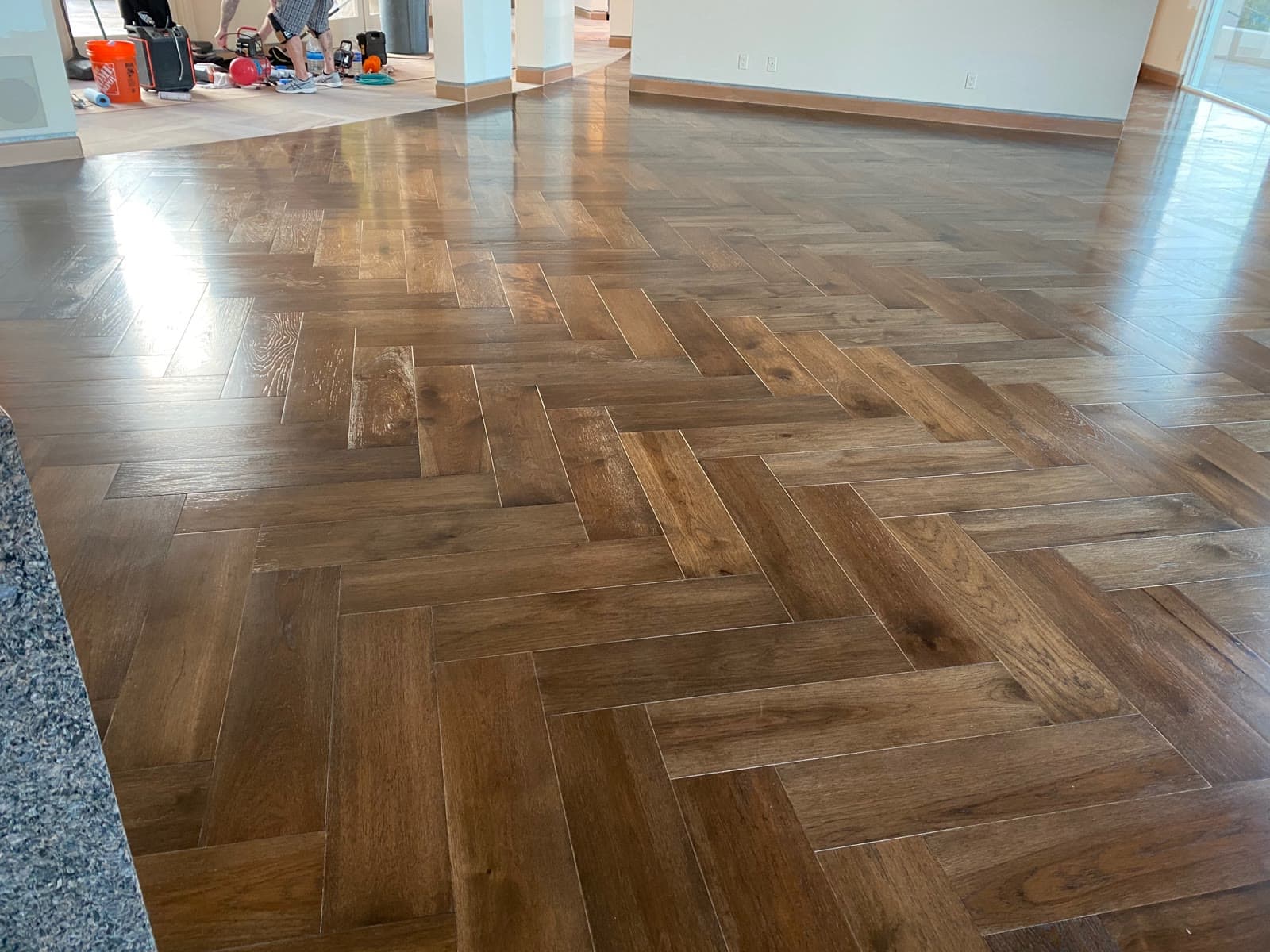 Large-format herringbone wood floor running through an open-plan Rancho Santa Fe great room