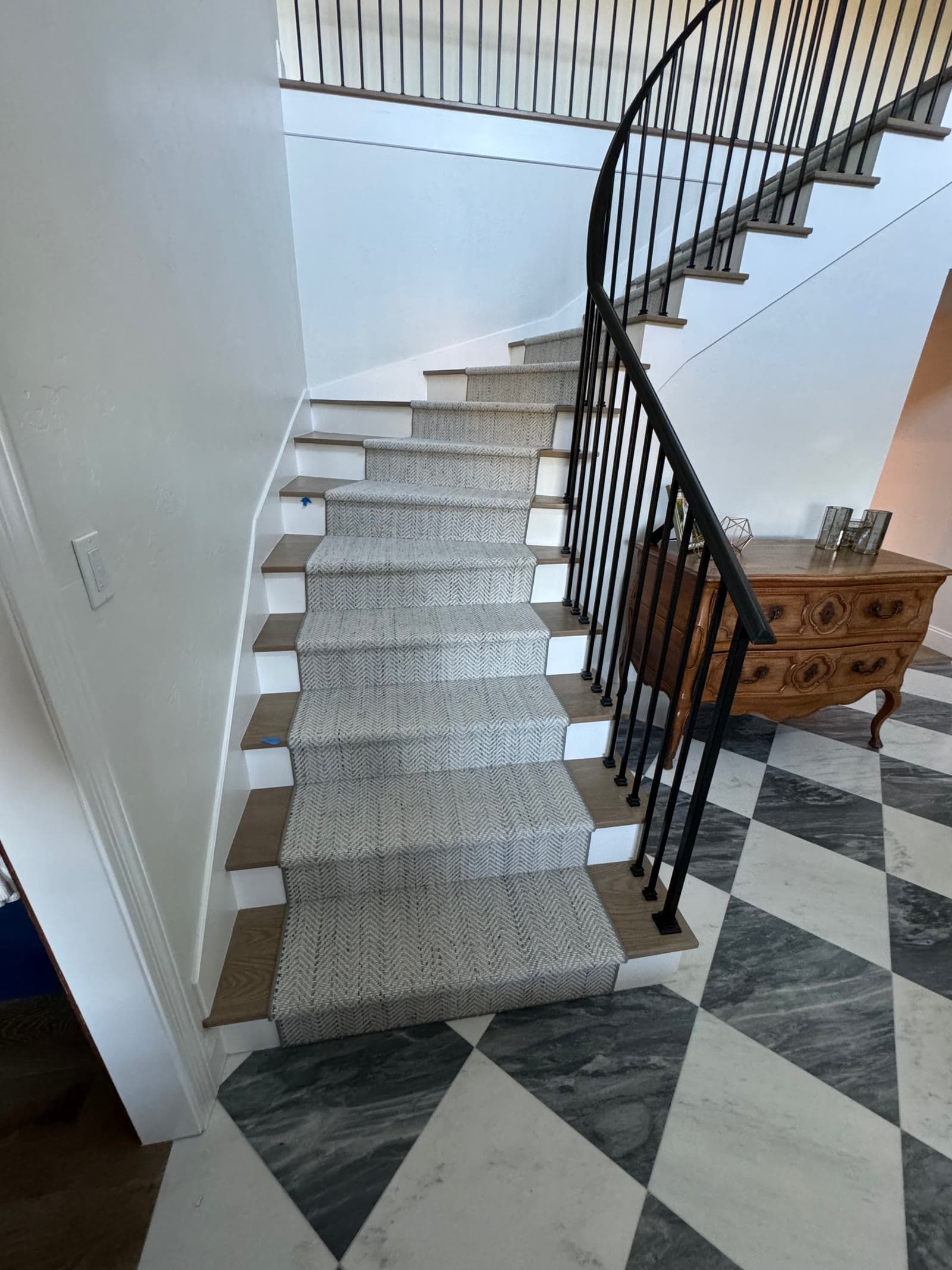 White oak stair treads with white risers and a wool runner above a marble checkerboard entry, Rancho Santa Fe