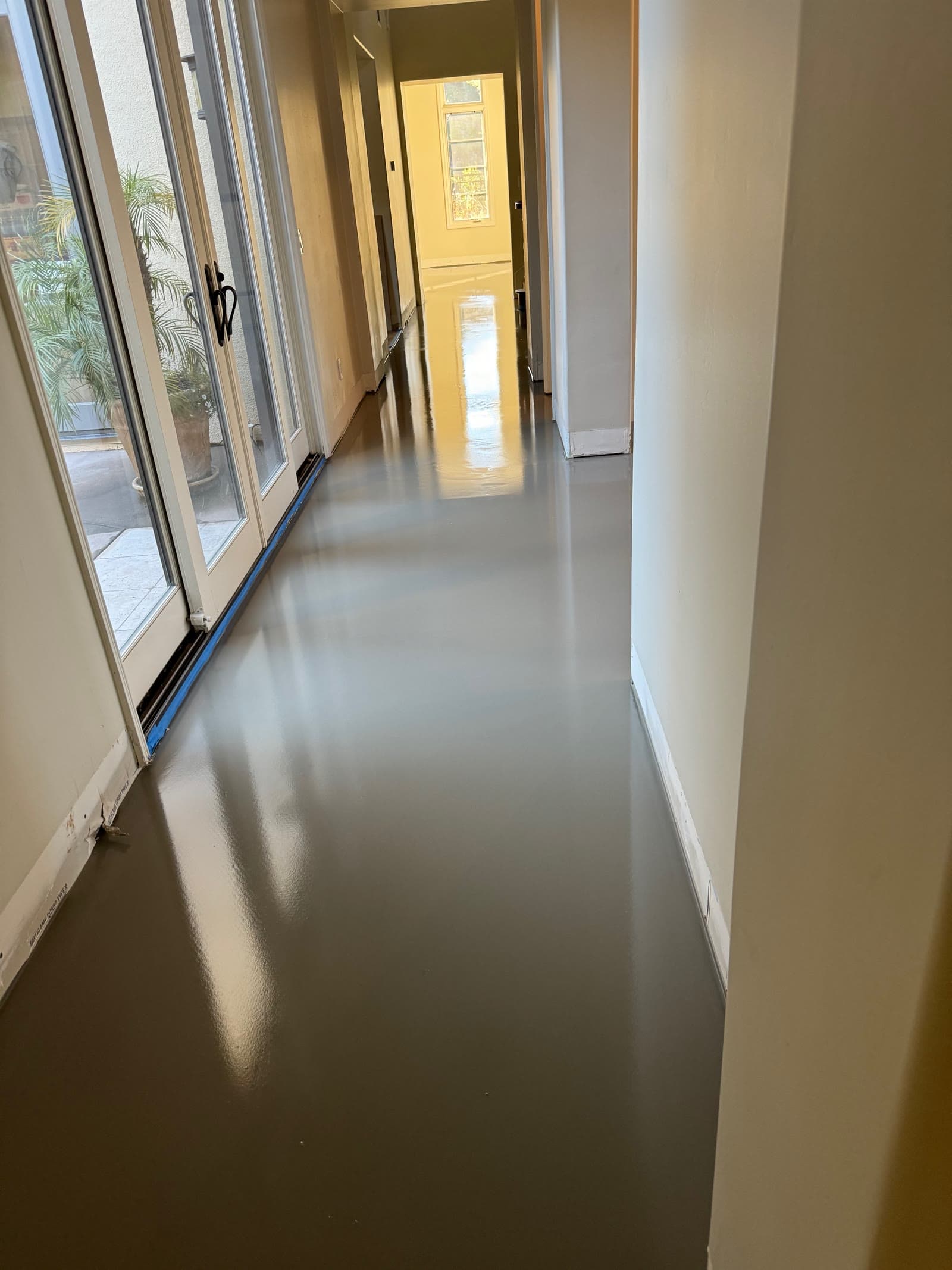 Self-leveling compound poured the length of a Santaluz hallway